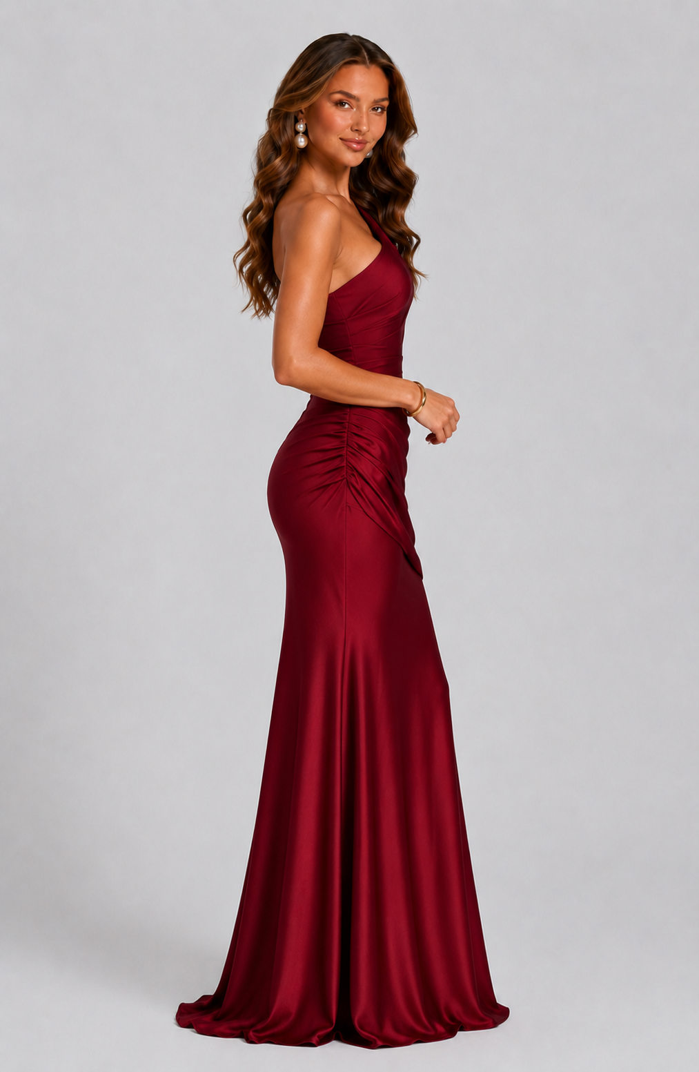 Side view of the deep red dress, showing the ruched side seam, fitted shape and flared train. 11