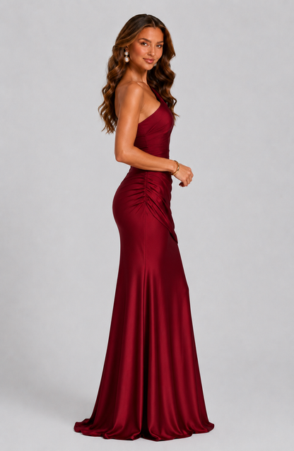 Side view of the deep red dress, showing the ruched side seam, fitted shape and flared train. 11