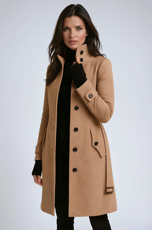 Model in a camel buttoned coat with belt, adjusting the stand-up collar over black knitwear 1