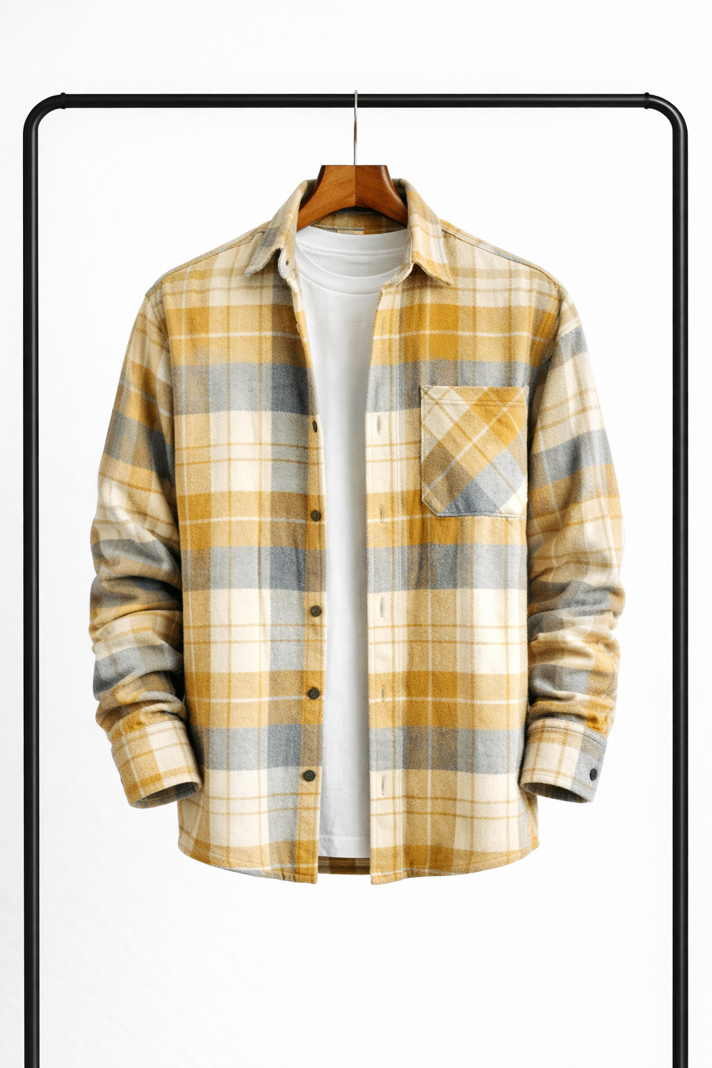 Overshirt in a yellow, grey and cream check hanging open over a white tee, with a buttoned chest pocket. 4
