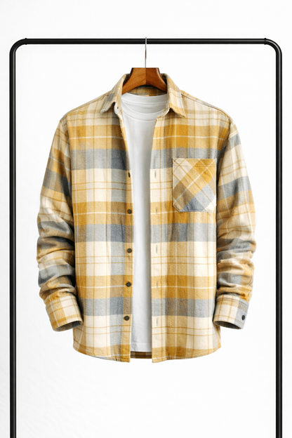 Overshirt in a yellow, grey and cream check hanging open over a white tee, with a buttoned chest pocket. 4