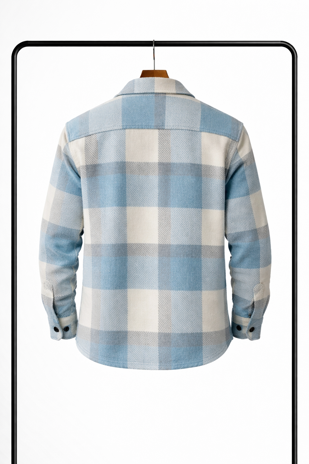 Back view of the pale blue, cream and grey check overshirt on a wooden hanger, showing the yoke and buttoned cuffs. 2
