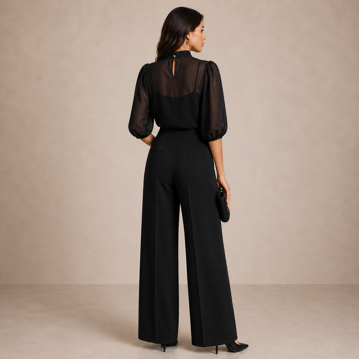 Back view of the black set on a model, showing the keyhole fastening at the blouse neck 2