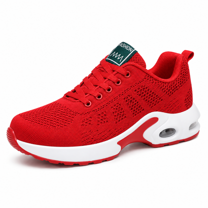 Side view of a bright red mesh trainer with matching laces, a white midsole and a visible air cushion unit. 3