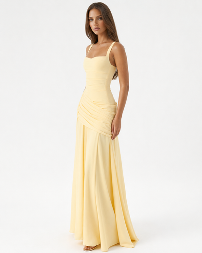Pale yellow dress worn at a three-quarter angle, showing the draped ruched hip panel and sweeping skirt 2