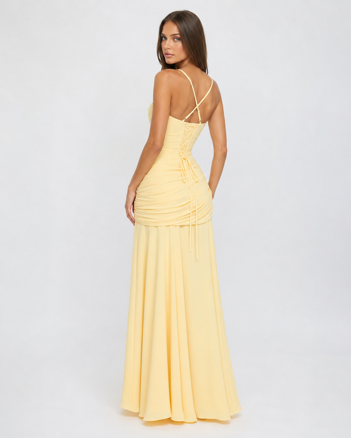 Back view of the pale yellow dress showing crossed straps, lace-up corset back and ruched hip 4