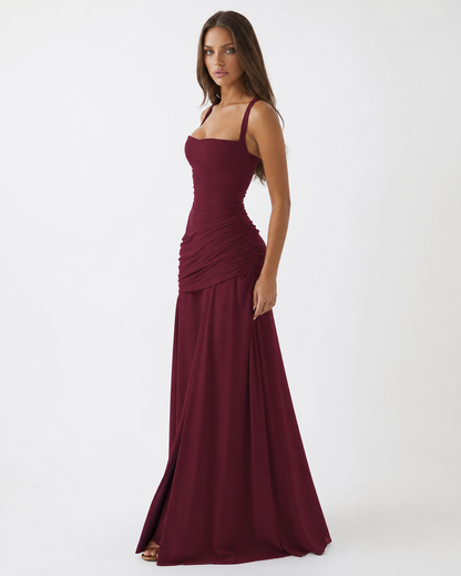 Burgundy dress at a three-quarter angle, showing the structured bodice and draped hip panel 18