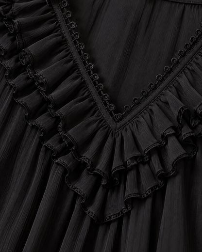 Close-up detail of the ruffled V-neckline in crinkled black chiffon, with looped trim and scalloped, finely stitched ruffle edges. 5