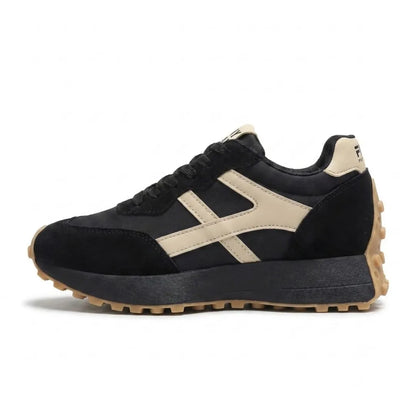 Side view of a black trainer with cream side stripes and gum-coloured outsole 16