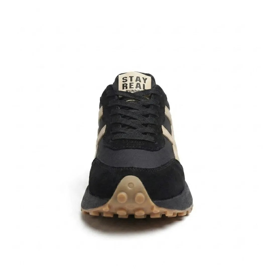 Front view of the black and cream trainer showing laces, tongue label and gum toe sole 19