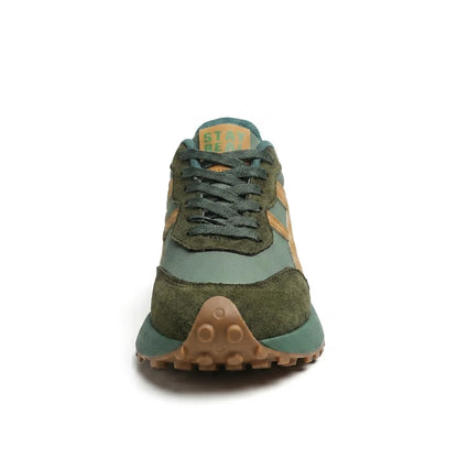 Front view of the green trainer showing dark green laces and studded gum toe sole 14