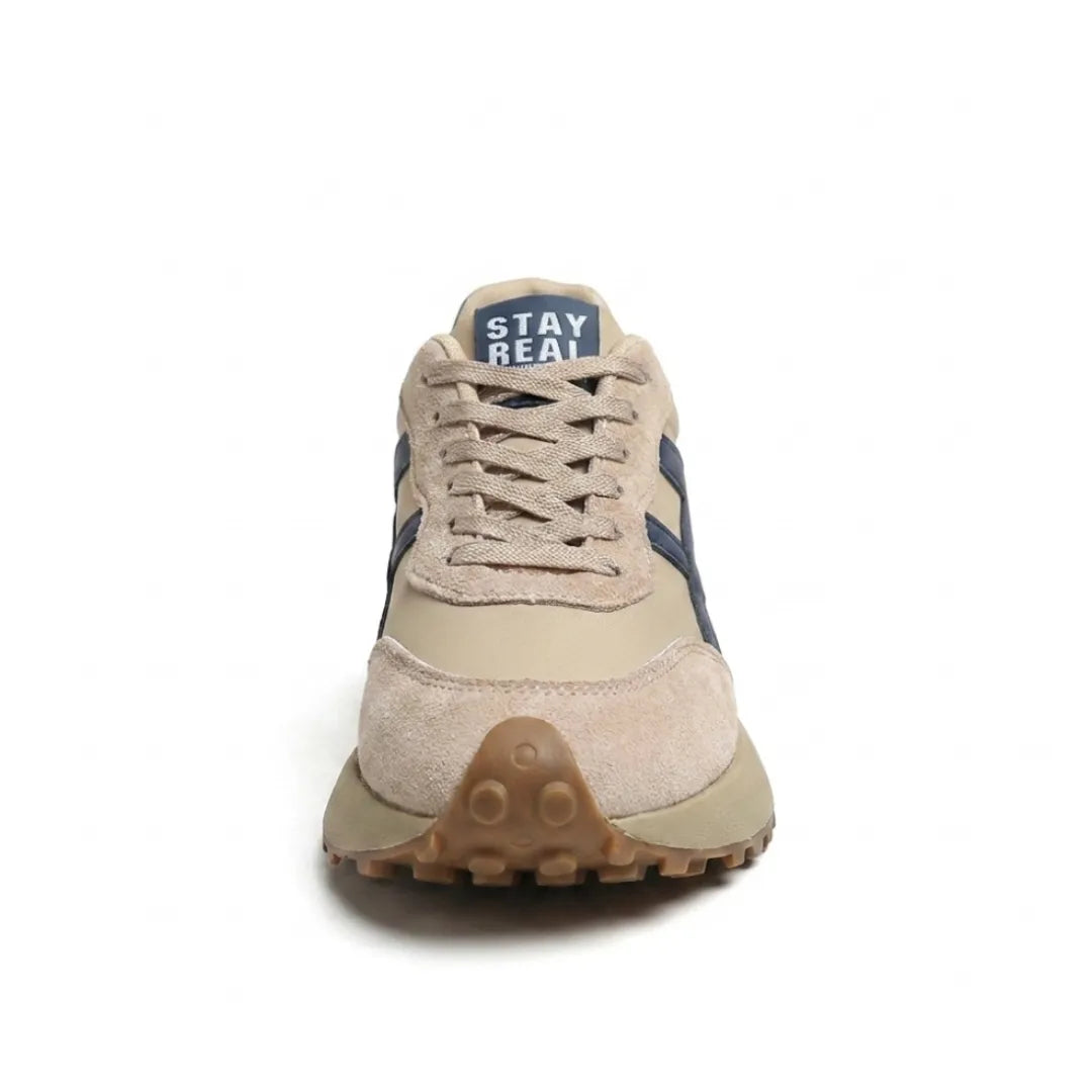 Front view of the beige trainer showing lacing, navy tongue label and studded toe sole 4