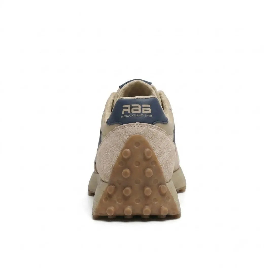 Rear view of the beige trainer showing navy heel tab and studded gum heel sole 5