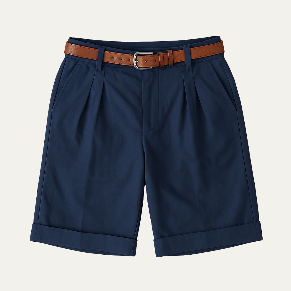 Navy pleated shorts with turn-up hems, laid flat from the front with a tan leather belt and silver buckle. 9