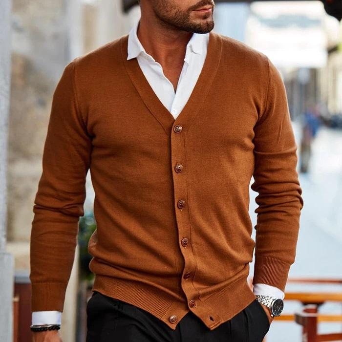 Model wearing the cardigan in rust brown over a white shirt and black trousers, walking outdoors 2