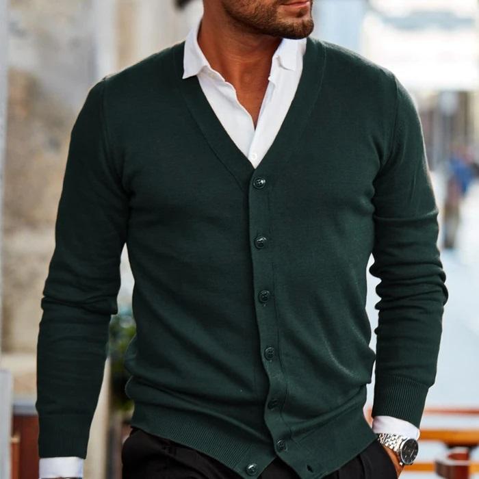 Model wearing the cardigan in dark forest green, buttoned over a white collared shirt 3