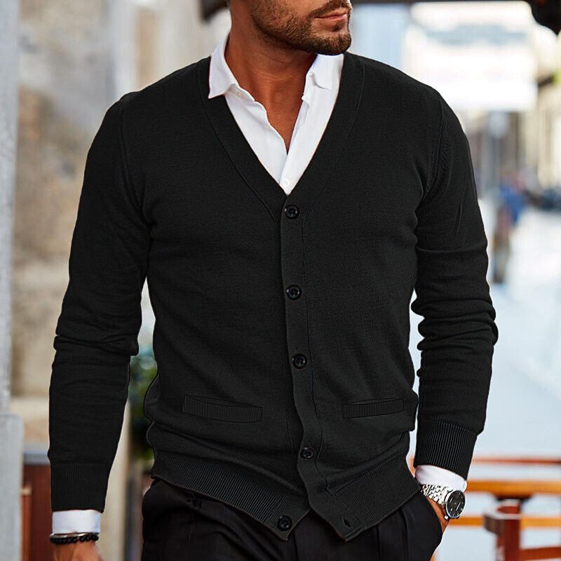 Model wearing the black cardigan, showing two small front pockets and ribbed cuffs and hem 5