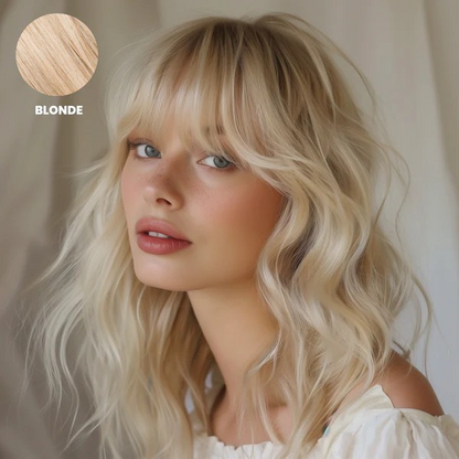 Model with soft wavy pale blonde hair and a full fringe, with colour swatch 3