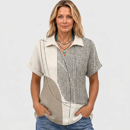 Model facing the camera in the cream and beige shirt, hands in jeans pockets, turquoise necklace 2