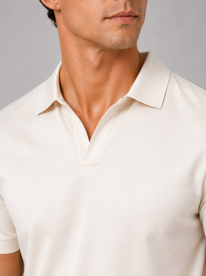 Close-up of the cream polo's collar and open V placket with neat stitching, showing the smooth, soft-looking fabric on the model's chest. 22