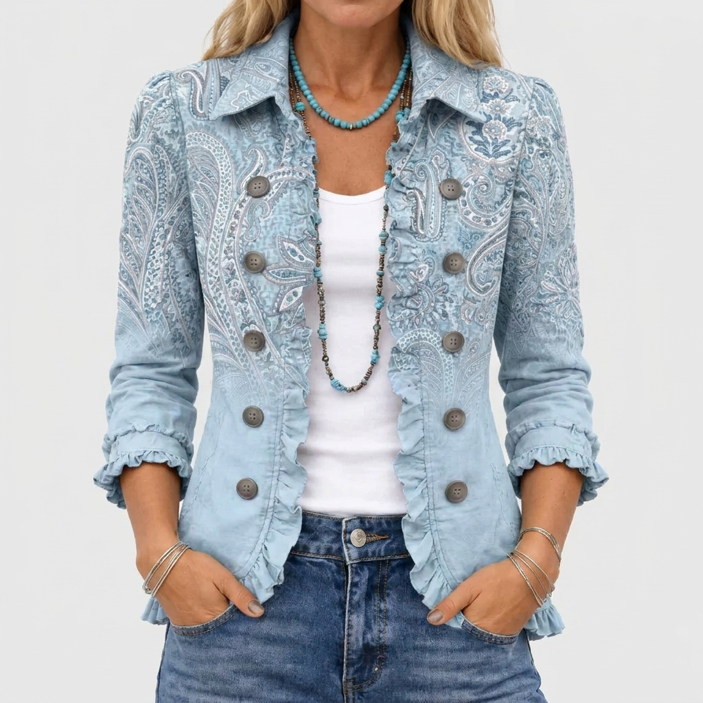 Close-up of the light blue paisley jacket worn open over a white vest and jeans 1