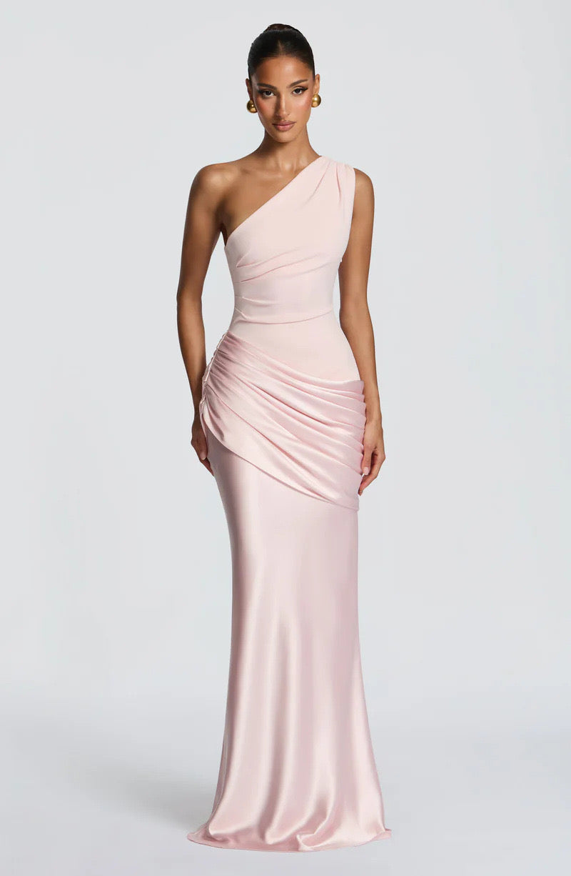 Front view of the dress in soft blush pink, with a pleated bodice and draped satin hip panel. 18