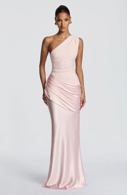 Front view of the dress in soft blush pink, with a pleated bodice and draped satin hip panel. 18