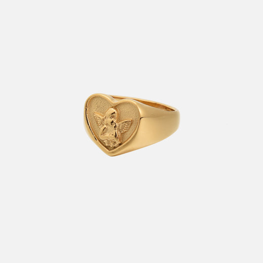 Gold-tone heart signet ring with a raised cherub in relief, shown from a three-quarter angle on white 1