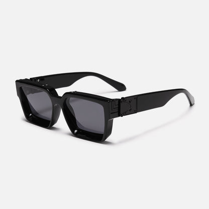 Chunky square glossy black sunglasses with dark grey lenses, angled three-quarter view showing the black metal hinge plate on the wide arm. 1