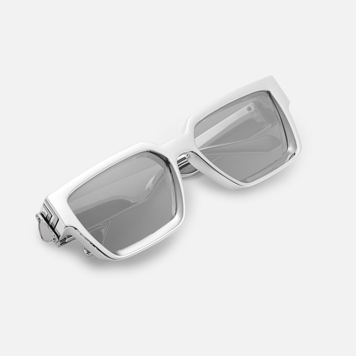 Folded silver chrome-finish sunglasses with mirrored lenses, angled top-down view. 13