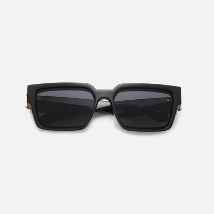Black square sunglasses with dark lenses and gold-coloured hinge details, folded and laid flat, front view. 9