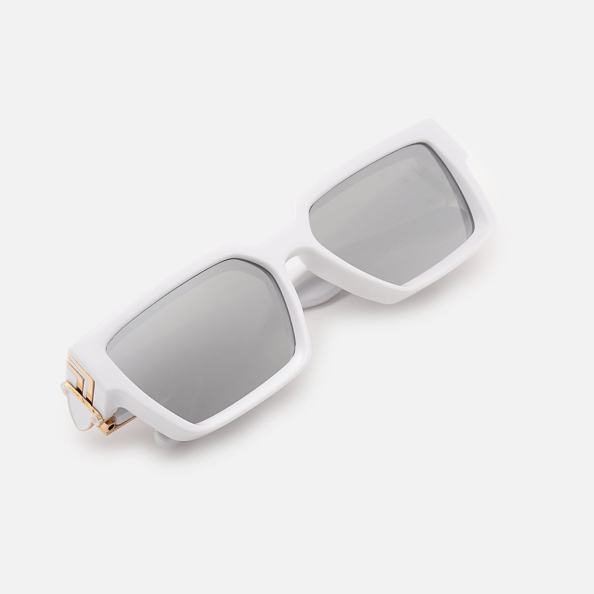 Folded white chunky sunglasses with silver mirrored lenses and gold-coloured hinge, angled top-down view. 19