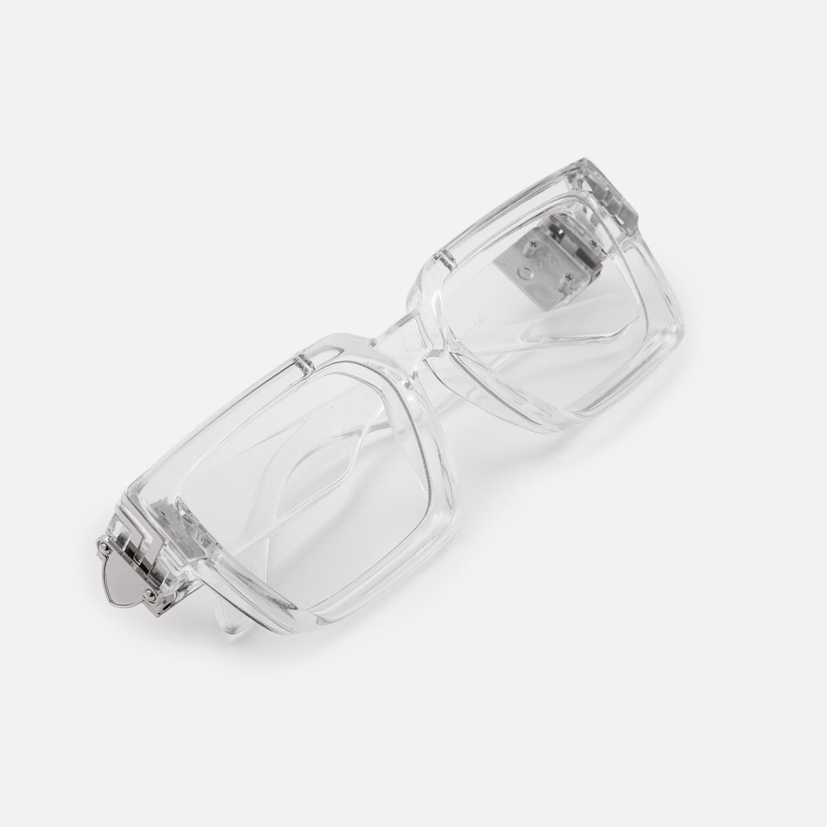 Folded clear acrylic glasses with silver hinge detail, shot at an angle to show the thick square frame and temple arms. 22