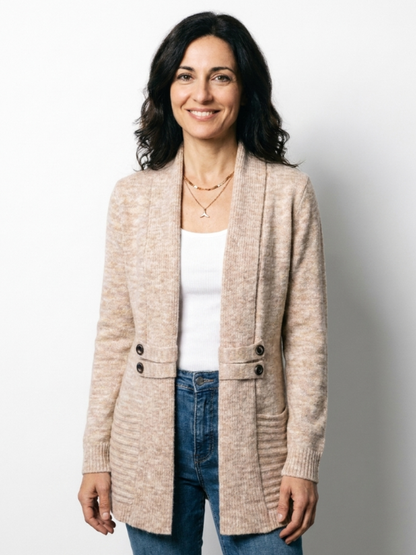 Smiling dark-haired model in the beige cardigan against a plain white backdrop, standing facing the camera 4