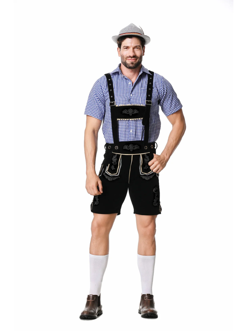 Smiling bearded man wearing the black lederhosen, blue gingham shirt, grey hat, white knee socks and brown boots, seen from the front. 4