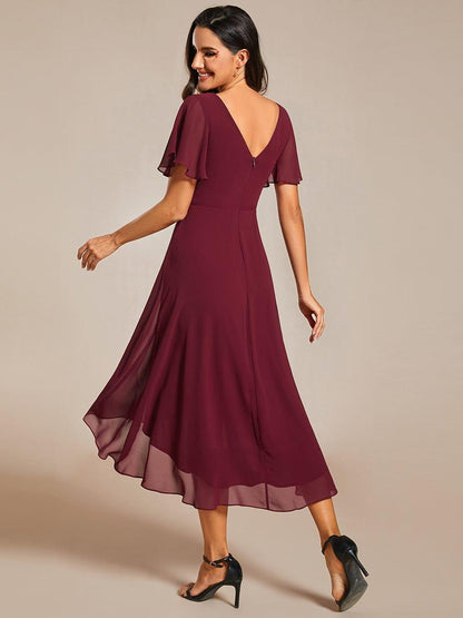 Back view of the burgundy dress, showing the V-shaped back, concealed zip and flowing layered high-low chiffon skirt. 4