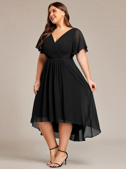 Plus-size model in the black dress, looking to the side with the layered chiffon hem lifting. 29