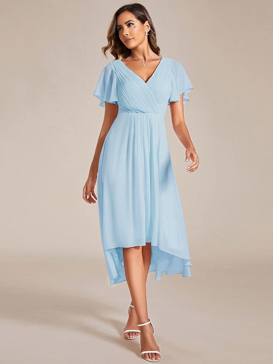 Model wearing the light blue high-low chiffon dress, front view, with white strappy heels and a layered necklace. 84
