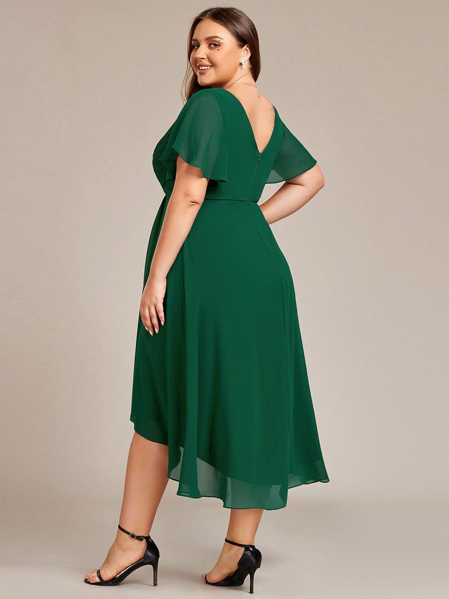 Deep green dress seen from behind on a plus-size model, showing the V back, zip and sheer sleeves. 37