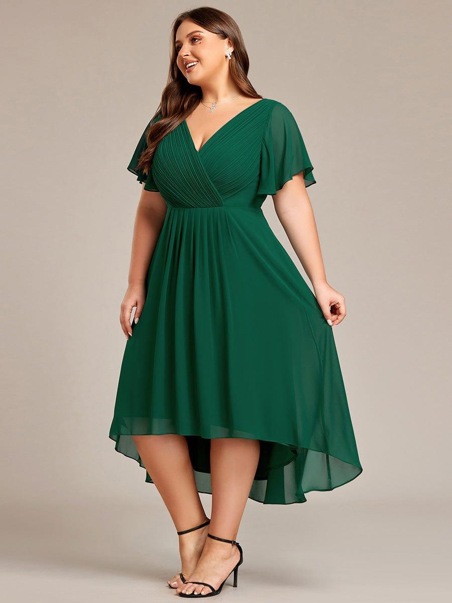 Plus-size model in the deep green dress, smiling sideways with the sheer layered hem flowing. 39