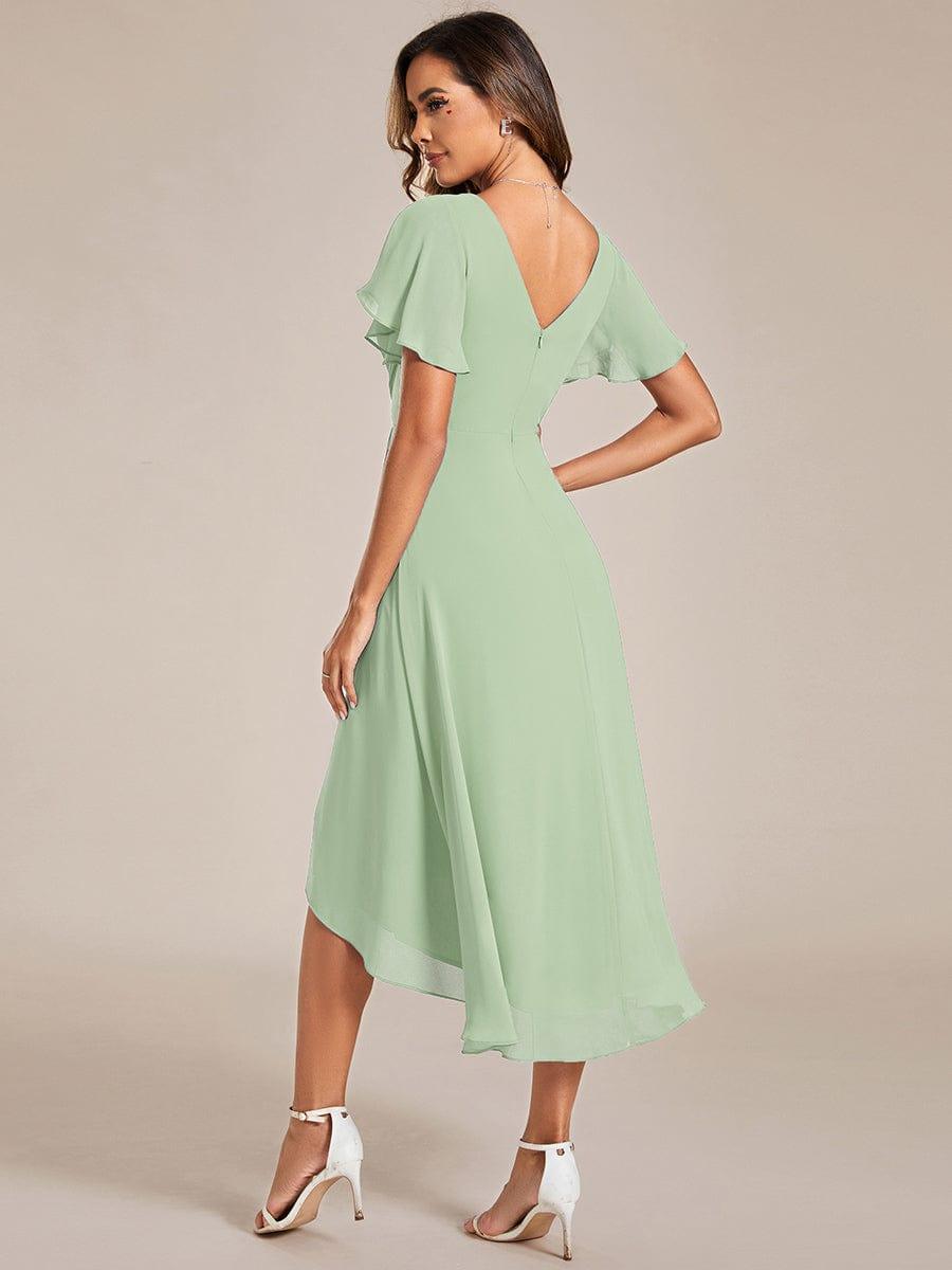 Back view of the sage green dress, showing the V-shaped back, zip and sweeping high-low hem. 77
