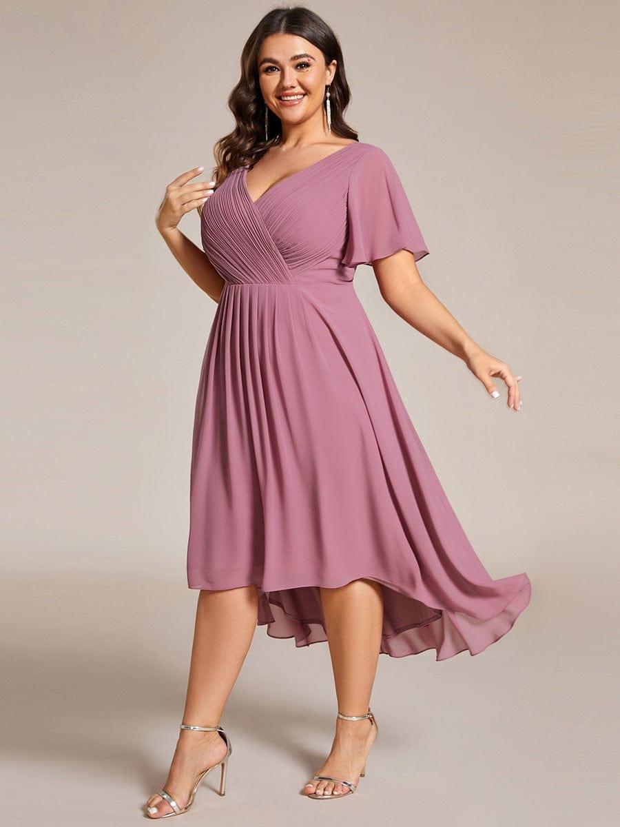 Plus-size model in the dusky pink dress in a twirling pose, showing the movement of the chiffon skirt. 67