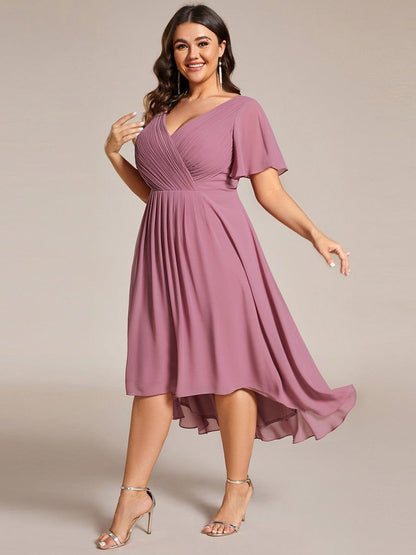 Plus-size model in the dusky pink dress in a twirling pose, showing the movement of the chiffon skirt. 67