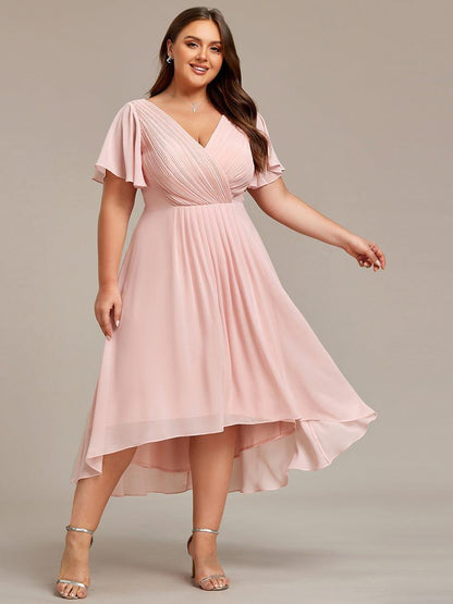 Plus-size model in the pale pink dress with one arm outstretched, showing the layered high-low skirt. 34