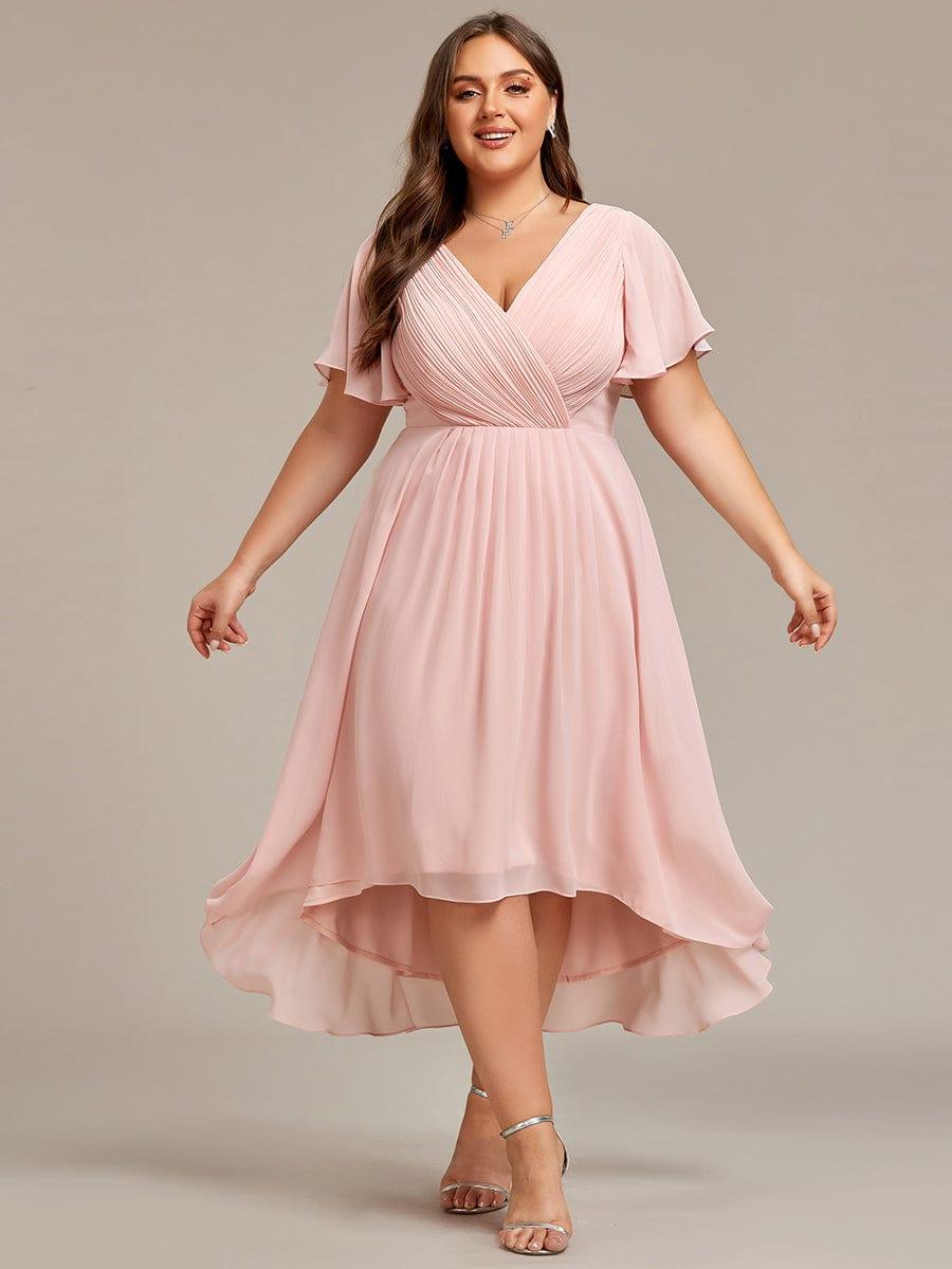 Plus-size model in the pale pink dress facing the camera, arms out to show the full pleated skirt. 35
