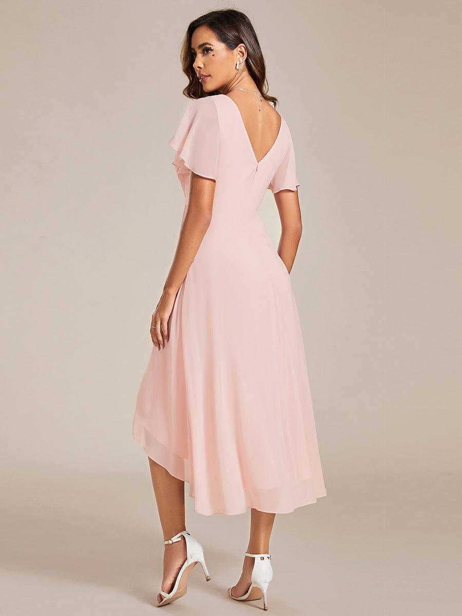 Back view of the pink dress, showing the low V-back, concealed zip, flutter sleeves and asymmetric chiffon hem. 16