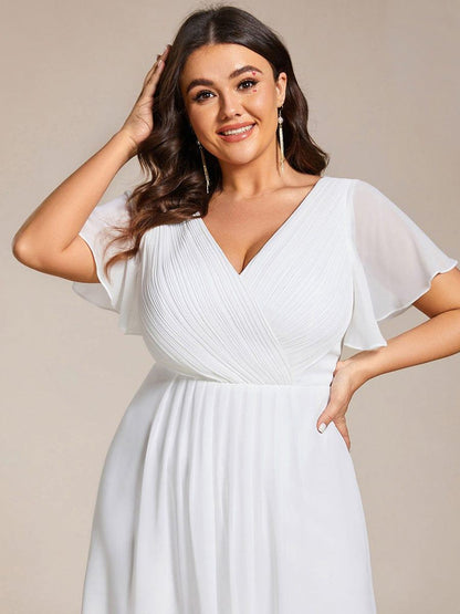 Close-up of the white dress's pleated bodice and sheer flutter sleeves on a plus-size model. 75