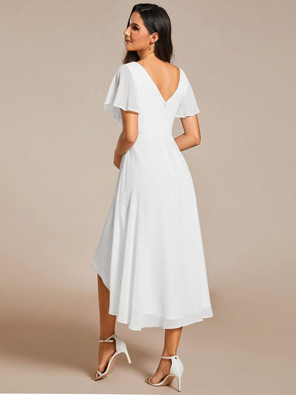 Back view of the white dress, showing the low V-back, zip and longer hem at the back. 69
