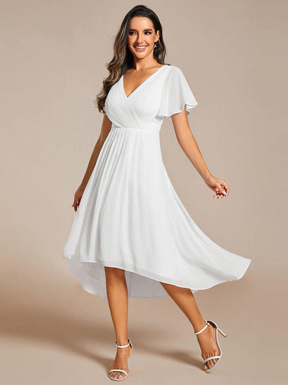 Model in the white dress mid-twirl, showing the swirling high-low chiffon hem. 72