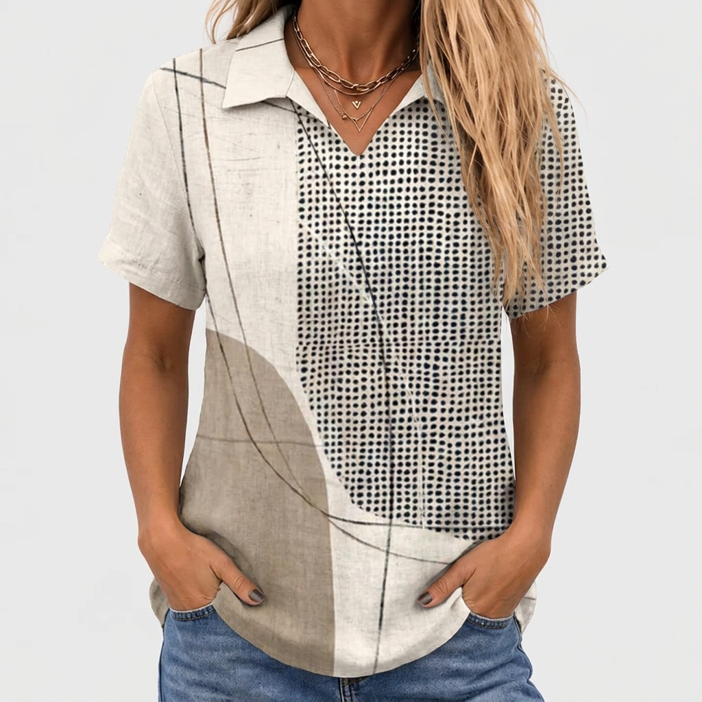 Close-up crop of the short-sleeved shirt worn with jeans, showing the V-neck collar and dotted panel 1